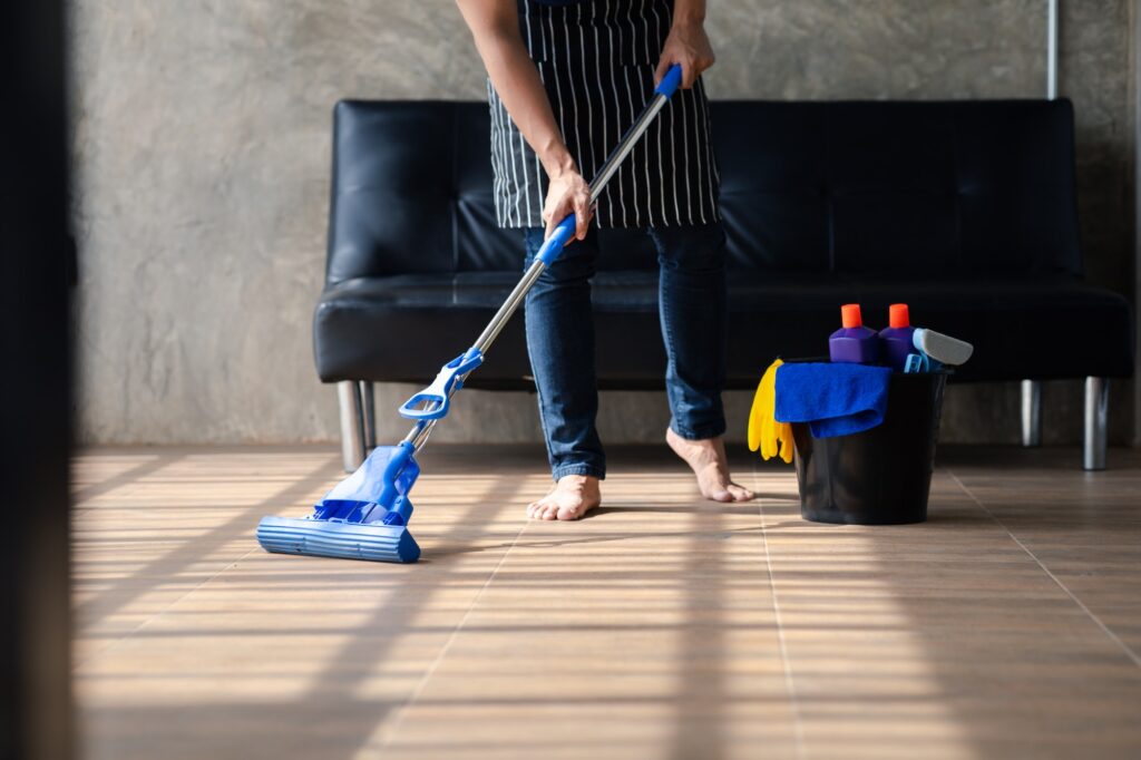 The cleaning equipment bins of the cleaners are placed on the floor.